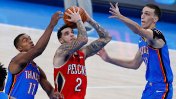 Pelicans guard Lonzo Ball (2) goes to the basket between OKC Thunder forward Aleksej Pokusevski (17) and guard Theo Maledon: Alonzo Adams-USA TODAY Sports