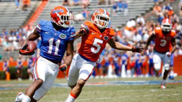 Apr 12, 2014; Gainesville, FL, USA; Florida Gators wide receiver Demarcus Robinson (11) is defended by defensive back Jalen Tabor (5) during the first half of the spring game at Ben Hill Griffin Stadium. Mandatory Credit: Rob Foldy-USA TODAY Sports