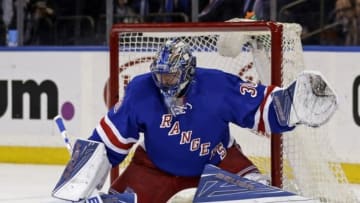 Jan 19, 2016; New York, NY, USA; New York Rangers goalie Henrik Lundqvist (30) makes a save against the Vancouver Canucks during the first period of an NHL hockey game at Madison Square Garden. Mandatory Credit: Adam Hunger-USA TODAY Sports