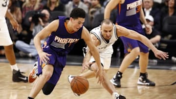Nov 23, 2015; San Antonio, TX, USA; San Antonio Spurs shooting guard Manu Ginobili (R) tries to steal the ball from Phoenix Suns shooting guard Devin Booker (L) during the first half at AT&T Center. Mandatory Credit: Soobum Im-USA TODAY Sports