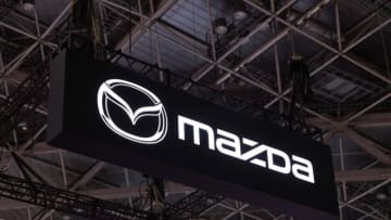 TOKYO, JAPAN - 2023/10/25: Japanese car maker Mazda company logo above their exhibition area during the Japan Mobility Show 2023 in Tokyo Big Sight. The Japan Mobility Show 2023 is the biggest car exhibition event in Japan. It is held from October 28th to November 5th 2023. On October 25th and 26th, the international press received access to take a look at new car concepts and visions for the future of mobility in Japan and around the world. (Photo by Stanislav Kogiku/SOPA Images/LightRocket via Getty Images)