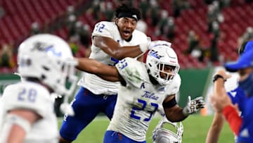 Oct 23, 2020; Tampa, Florida, USA; Tulsa Golden Hurricane linebacker Zaven Collins (23) and tight end James Palmer (32) celebrate after he returned an interception for a touchdown in the second half against the South Florida Bulls at Raymond James Stadium. Mandatory Credit: Jonathan Dyer-USA TODAY Sports