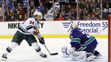 VANCOUVER, BC - FEBRUARY 28: Mikael Granlund #64 of the Minnesota Wild is stopped by goaltender Eddie Lack #31 of the Vancouver Canucks during a shootout of their NHL game at Rogers Arena on February 28, 2014 in Vancouver, British Columbia, Canada. (Photo by Ben Nelms/Getty Images)