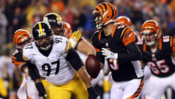 Jan 9, 2016; Cincinnati, OH, USA; Cincinnati Bengals quarterback AJ McCarron (5) rolls out against Pittsburgh Steelers defensive end Cameron Heyward (97) during the second quarter in the AFC Wild Card playoff football game at Paul Brown Stadium. Mandatory Credit: Aaron Doster-USA TODAY Sports
