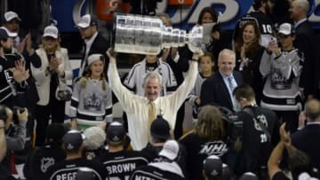 Jun 13, 2014; Los Angeles, CA, USA; Los Angeles Kings head coach Darryl Sutter hoists the Stanley Cup after defeating the New York Rangers in the second overtime period in game five of the 2014 Stanley Cup Final at Staples Center. Mandatory Credit: Richard Mackson-USA TODAY Sports