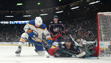Apr 14, 2023; Columbus, Ohio, USA; Buffalo Sabres center Casey Mittelstadt (37) and Columbus Blue Jackets defenseman Andrew Peek (2) battle for the during the third period at Nationwide Arena. Mandatory Credit: Jason Mowry-USA TODAY Sports