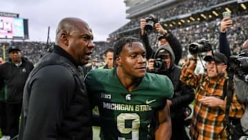 Michigan State's head coach Mel Tucker, left, hugs Kenneth Walker III after beating Michigan on Saturday, Oct. 30, 2021, at Spartan Stadium in East Lansing.211030 Msu Michigan 298a