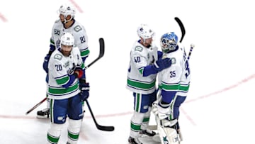 EDMONTON, ALBERTA - SEPTEMBER 04: Elias Pettersson #40 of the Vancouver Canucks consoles Thatcher Demko #35 after their teams 3-0 defeat against the Vegas Golden Knights during in Game Seven of the Western Conference Second Round during the 2020 NHL Stanley Cup Playoffs at Rogers Place on September 04, 2020 in Edmonton, Alberta, Canada. (Photo by Bruce Bennett/Getty Images)
