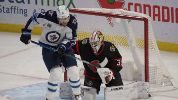Jan 19, 2021; Ottawa, Ontario, CAN; Winnipeg Jets center Adam Lowry (17) screens a shot in front of Ottawa Senators goalie Matt Murray (30) in the third period at the Canadian Tire Centre. Mandatory Credit: Marc DesRosiers-USA TODAY Sports