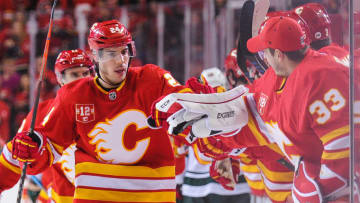CALGARY, AB - MARCH 2: Travis Hamonic #24 of the Calgary Flames celebrates with his teammates after scoring against the Minnesota Wild during an NHL game at Scotiabank Saddledome on March 2, 2019 in Calgary, Alberta, Canada. (Photo by Derek Leung/Getty Images)