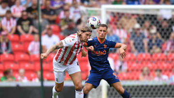 STOKE ON TRENT, ENGLAND - AUGUST 06: Aden Flint of Stoke City is Challenged by Jerry Yates of Blackpool during the Sky Bet Championship match between Stoke City and Blackpool at Bet365 Stadium on August 06, 2022 in Stoke on Trent, England. (Photo by Tony Marshall/Getty Images)