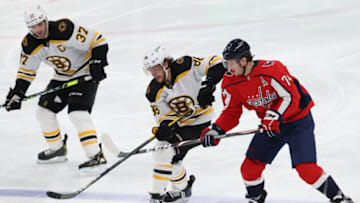 Feb 1, 2021; Washington, District of Columbia, USA; Boston Bruins right wing David Pastrnak (88) and Washington Capitals defenseman John Carlson (74) battle for the puck in the third period at Capital One Arena. Mandatory Credit: Geoff Burke-USA TODAY Sports