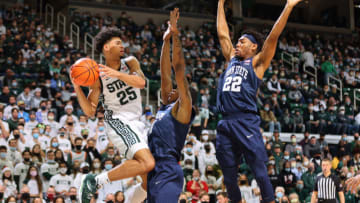 Malik Hall #25 of the Michigan State Spartans looks to pass the ball against Jalen Pickett #22 and Sam Sessoms #3 of the Penn State Nittany Lions (Photo by Rey Del Rio/Getty Images)