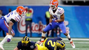 ATLANTA, GEORGIA - DECEMBER 29: CJ Henderson #5 of the Florida Gators celebrates his first quarter sack on Shea Patterson #2 of the Michigan Wolverines during the Chick-fil-A Peach Bowl at Mercedes-Benz Stadium on December 29, 2018 in Atlanta, Georgia. (Photo by Joe Robbins/Getty Images)