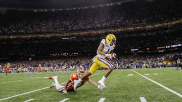 NEW ORLEANS, LA - JANUARY 13: Wide Receiver Ja'Marr Chase #1 of the LSU Tigers makes a catch over Cornerback A.J. Terrell #8 of the Clemson Tigers for a touchdown during the College Football Playoff National Championship game at the Mercedes-Benz Superdome on January 13, 2020 in New Orleans, Louisiana. LSU defeated Clemson 42 to 25. (Photo by Don Juan Moore/Getty Images)
