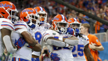 ATLANTA, GEORGIA - DECEMBER 29: Lamical Perine #22 of the Florida Gators is congratulated by his teammates after scoring a fourth quarter rushing touchdown against the Michigan Wolverines during the Chick-fil-A Peach Bowl at Mercedes-Benz Stadium on December 29, 2018 in Atlanta, Georgia. (Photo by Mike Zarrilli/Getty Images)