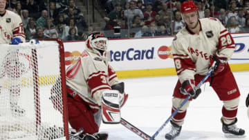 Goaltender Martin Broduer #30 and Brian Rafalski #28 of the New Jersey Devils defend their goal during the 54th NHL All-Star Game on February 8, 2004 at the Xcel Energy Center in St. Paul, Minnesota. (Photo by Harry How/Getty Images)