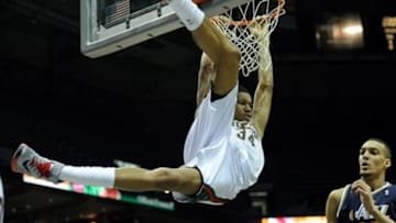 Mar 3, 2014; Milwaukee, WI, USA; Milwaukee Bucks guard Giannis Antetokounmpo (34) hangs on the rim after dunking against Utah Jazz center Rudy Gobert (27) in the 4th quarter at BMO Harris Bradley Center. Mandatory Credit: Benny Sieu-USA TODAY Sports