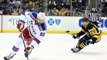 Mar 3, 2016; Pittsburgh, PA, USA; New York Rangers defenseman Keith Yandle (93) gathers the puck ahead of Pittsburgh Penguins right wing Patric Hornqvist (72) during the second period at the CONSOL Energy Center. The Penguins won 4-1. Mandatory Credit: Charles LeClaire-USA TODAY Sports