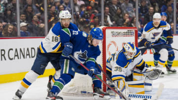 Mar 30, 2022; Vancouver, British Columbia, CAN; St. Louis Blues goaltender Ville Husso (35) makes a save as forward Robert Thomas (18) checks Vancouver Canucks forward Vasily Podkolzin (92) in the third period at Rogers Arena. Mandatory Credit: Bob Frid-USA TODAY Sports