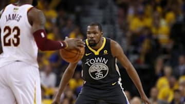 OAKLAND, CA - JUNE 03: Kevin Durant #35 of the Golden State Warriors defends against LeBron James #23 of the Cleveland Cavaliers in Game 2 of the 2018 NBA Finals at ORACLE Arena on June 3, 2018 in Oakland, California. NOTE TO USER: User expressly acknowledges and agrees that, by downloading and or using this photograph, User is consenting to the terms and conditions of the Getty Images License Agreement. (Photo by Ezra Shaw/Getty Images)