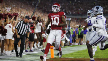 NORMAN, OK - SEPTEMBER 24: Wide receiver Theo Wease Jr. #10 of the Oklahoma Sooners scores a touchdown on a 56-yard catch against safety Cincere Mason #9 of the Kansas State Wildcats in the first quarter at Gaylord Family Oklahoma Memorial Stadium on September 24, 2022 in Norman, Oklahoma. Kansas State won 41-34. (Photo by Brian Bahr/Getty Images)