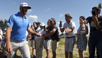 Jun 17, 2016; Oakmont, PA, USA; Dustin Johnson greets spectators as he walks off the 13th hole during the second round of the U.S. Open golf tournament at Oakmont Country Club. Mandatory Credit: John David Mercer-USA TODAY Sports