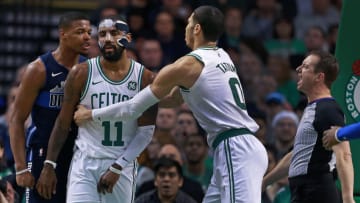 BOSTON - DECEMBER 6: Dallas Mavericks' Dennis Smith Jr. and the Celtics' Kyrie Irving (11) react after an incident under the basket in the first quarter that saw both get technical fouls called on them. Boston's Jayson Tatum (0) moves in to pull Irving away. The Boston Celtics host the Dallas Mavericks in a regular season NBA basketball game at TD Garden in Boston on Dec. 6, 2017. (Photo by Jim Davis/The Boston Globe via Getty Images)
