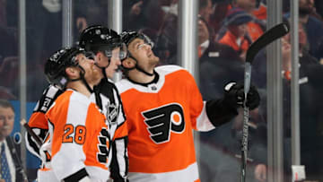PHILADELPHIA, PA - NOVEMBER 15: Referee TJ Luxmore #21, along with Claude Giroux #28 and James van Riemsdyk #25 of the Philadelphia Flyers, watch a replay of a disputed power-play goal during the first period against the New Jersey Devils on November 15, 2018 at the Wells Fargo Center in Philadelphia, Pennsylvania. The goal was dis-allowed. (Photo by Len Redkoles/NHLI via Getty Images)