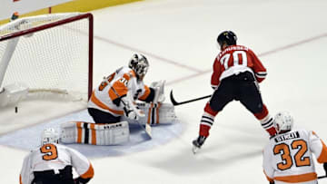 Oct 18, 2016; Chicago, IL, USA; Chicago Blackhawks center Dennis Rasmussen (70) scores a goal against Philadelphia Flyers goalie Michal Neuvirth (30) during the first period at the United Center. Mandatory Credit: David Banks-USA TODAY Sports