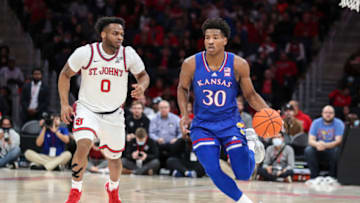 Kansas Jayhawks guard Ochai Agbaji drives past St. John’s basketball guard Posh Alexander (0) in the first half at UBS Arena. (Wendell Cruz-USA TODAY Sports)