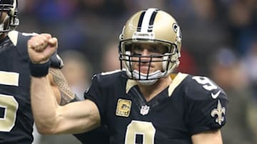 Nov 8, 2015; New Orleans, LA, USA; New Orleans Saints quarterback Drew Brees (9) reacts with guard Senio Kelemete (65) after throwing a touchdown pass against the Tennessee Titans in the fourth quarter of their game at the Mercedes-Benz Superdome. The Titans won, 34-28, in overtime. Mandatory Credit: Chuck Cook-USA TODAY Sports