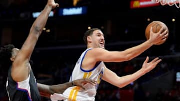 Feb 20, 2016; Los Angeles, CA, USA; Golden State Warriors guard Klay Thompson (11) gets by Los Angeles Clippers center DeAndre Jordan (6) for a basket in the first half of the game at Staples Center. Mandatory Credit: Jayne Kamin-Oncea-USA TODAY Sports