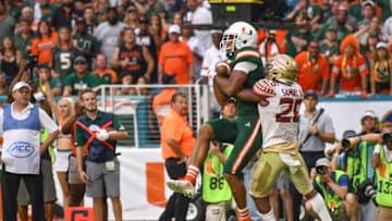 MIAMI, FL - OCTOBER 06: Lawrence Cager #18 of the Miami Hurricanes scores a touchdown in the second half against the Florida State Seminoles at Hard Rock Stadium on October 6, 2018 in Miami, Florida. (Photo by Mark Brown/Getty Images)
