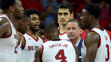 Jan 4, 2017; Raleigh, NC, USA; North Carolina State Wolfpack head coach Mark Gottfried (second from right) talks to his team during the second half against the Virginia Tech Hokies at PNC Arena. Mandatory Credit: Rob Kinnan-USA TODAY Sports