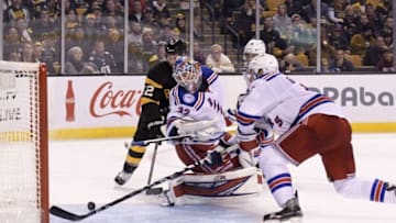 Nov 5, 2016; Boston, MA, USA; New York Rangers defenseman Dan Girardi (5) reaches for the puck behind goalie Antti Raanta (32) while Boston Bruins right wing David Backes (42) looks on during the third period at TD Garden. Mandatory Credit: Bob DeChiara-USA TODAY Sports