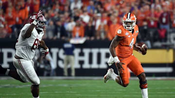 Jan 11, 2016; Glendale, AZ, USA; Clemson Tigers quarterback Deshaun Watson (4) runs the ball against Alabama Crimson Tide defensive lineman A'Shawn Robinson (86) during the first quarter in the 2016 CFP National Championship at University of Phoenix Stadium. Mandatory Credit: Kirby Lee-USA TODAY Sports
