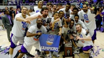 Mar 15, 2014; Ogden, UT, USA; The Weber State Wildcats basketball team pose with the trophy after winning the championship game of the Big Sky college basketball tournament against the North Dakota Fighting Sioux at Dee Event Center. Mandatory Credit: Chris Nicoll-USA TODAY Sports