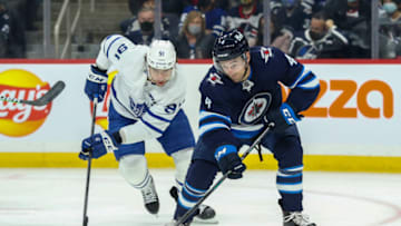 Winnipeg Jets, Neal Pionk (4); Toronto Maple Leafs John Taveres (91). Mandatory Credit: Terrence Lee-USA TODAY Sports
