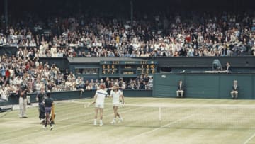 John McEnroe of the United States reaches over the net to shake hands with Bjorn Borg after defeating him during the Men's Singles Final match at the Wimbledon Lawn Tennis Championship on 4 July 1981 at the All England Lawn Tennis and Croquet Club in Wimbledon in London, England. (Photo by Tony Duffy/Allsport/Getty Images)