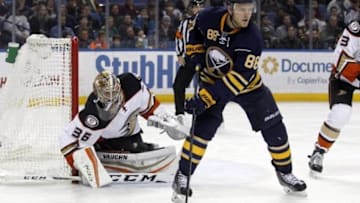 Dec 17, 2015; Buffalo, NY, USA; Anaheim Ducks goalie John Gibson (36) tries to find the puck around Buffalo Sabres left wing Jamie McGinn (88) during the second period at First Niagara Center. Mandatory Credit: Timothy T. Ludwig-USA TODAY Sports