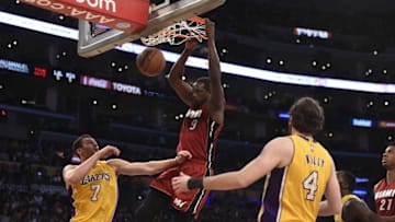 Mar 30, 2016; Los Angeles, CA, USA; Miami Heat forward Luol Deng (9) dunks over Los Angeles Lakers forward Ryan Kelly (4) and forward Larry Nance Jr. (7) during first half at Staples Center. Mandatory Credit: Richard Mackson-USA TODAY Sports