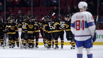 Jan 19, 2016; Montreal, Quebec, CAN; The Boston Bruins celebrate their 4-1 victory while Montreal Canadiens forward Lars Eller (81) heads to the dressing room at the Bell Centre. Mandatory Credit: Eric Bolte-USA TODAY Sports