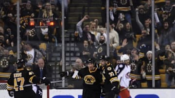 Jan 23, 2016; Boston, MA, USA; Boston Bruins left wing Brad Marchand (63) is congratulated by center Patrice Bergeron (37) and defenseman Torey Krug (47) after scoring a goal during the second period at TD Garden. Mandatory Credit: Bob DeChiara-USA TODAY Sports