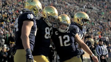 SOUTH BEND, INDIANA - NOVEMBER 16: Chase Claypool #83 and Ian Book #12 of the Notre Dame Fighting Irish celebrate after scoring a touchdown in the first quarter against the Navy Midshipmen at Notre Dame Stadium on November 16, 2019 in South Bend, Indiana. (Photo by Dylan Buell/Getty Images)
