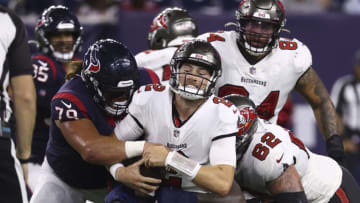 Aug 28, 2021; Houston, Texas, USA; Tampa Bay Buccaneers quarterback Kyle Trask (2) is sacked by Houston Texans defensive tackle Roy Lopez (79) during the fourth quarter at NRG Stadium. Mandatory Credit: Troy Taormina-USA TODAY Sports