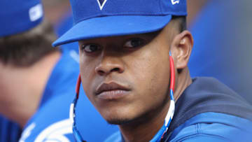 TORONTO, ON - AUGUST 11: Marcus Stroman #6 of the Toronto Blue Jays lets his sunglasses hang as he looks on from the top step of the dugout during MLB game action against the Tampa Bay Rays at Rogers Centre on August 11, 2018 in Toronto, Canada. (Photo by Tom Szczerbowski/Getty Images)