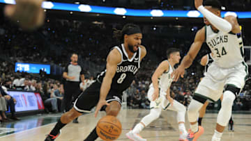 Oct 19, 2021; Milwaukee, Wisconsin, USA; Brooklyn Nets guard Patty Mills (8) drives to the basket against Milwaukee Bucks forward Giannis Antetokounmpo (34) in the first half at Fiserv Forum. Mandatory Credit: Michael McLoone-USA TODAY Sports
