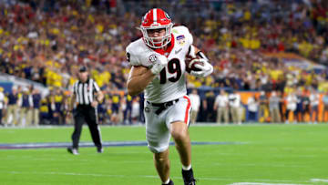 Brock Bowers runs the ball into the end zone for a touchdown against the Michigan Wolverines. (Photo by Kevin C. Cox/Getty Images)