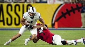 Sep 3, 2016; Glendale, AZ, USA; Brigham Young Cougars wide receiver Moroni Laulu-Pututau (1) runs the ball as he is tackled by Arizona Wildcats linebacker Cody Ippolito (57) during the first half at University of Phoenix Stadium. Mandatory Credit: Casey Sapio-USA TODAY Sports